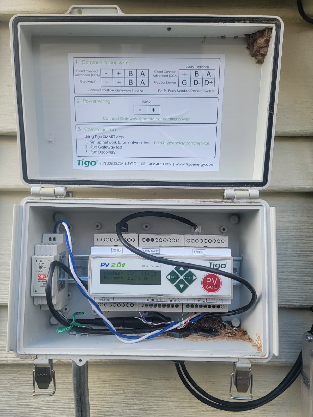 Tigo Cloud Connect monitoring gateway in an outdoor enclosure reporting node count and system power